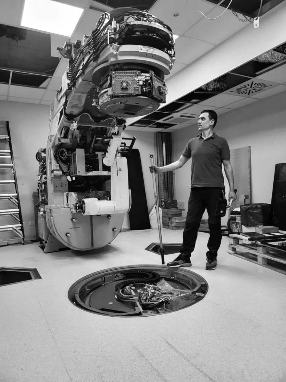 Team member beside the equipment with covers removed — INI Group Hospital, Rome, Italy