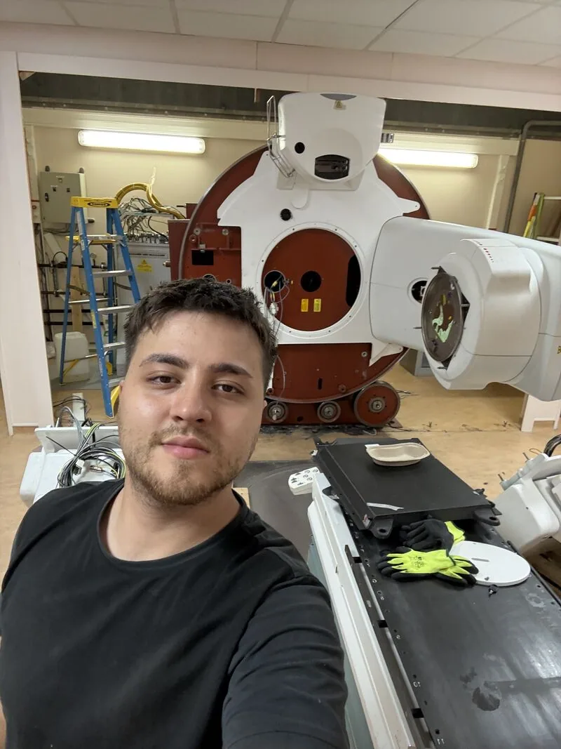 Project team beside the LINAC and patient table — Bobigny – IRHE