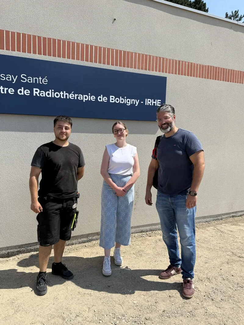 Project team in front of the facility sign — Bobigny – IRHE
