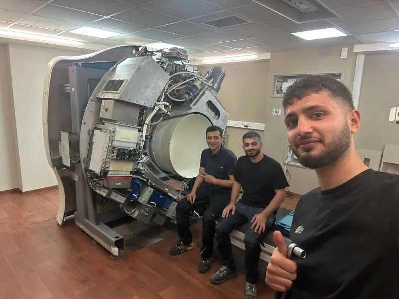 Field team beside the equipment with covers removed — Centre Antoine Lacassagne, France