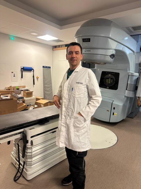Project team beside the LINAC and patient table — Carcassonne