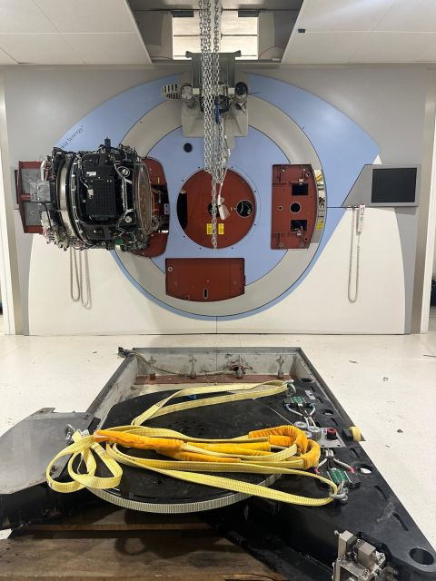 Detached table and equipment parts in front of the exposed gantry — Forcilles