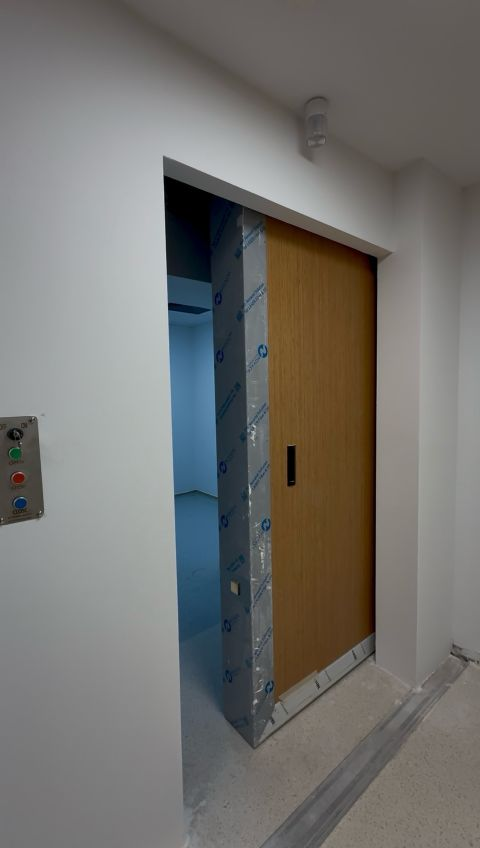 Open treatment-room door with a wood finish — Gaziantep