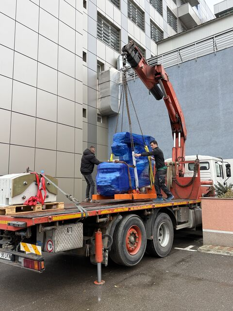 Wrapped unit being loaded onto the truck by crane — Iași