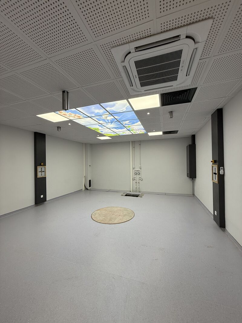 Room with illuminated decorative ceiling and equipment mounting area — Rize