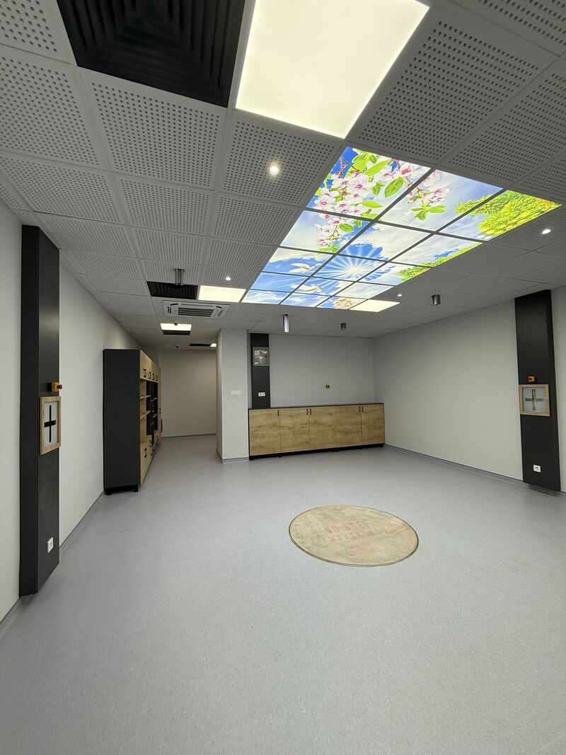 Cabinets and illuminated ceiling in the treatment room — Rize