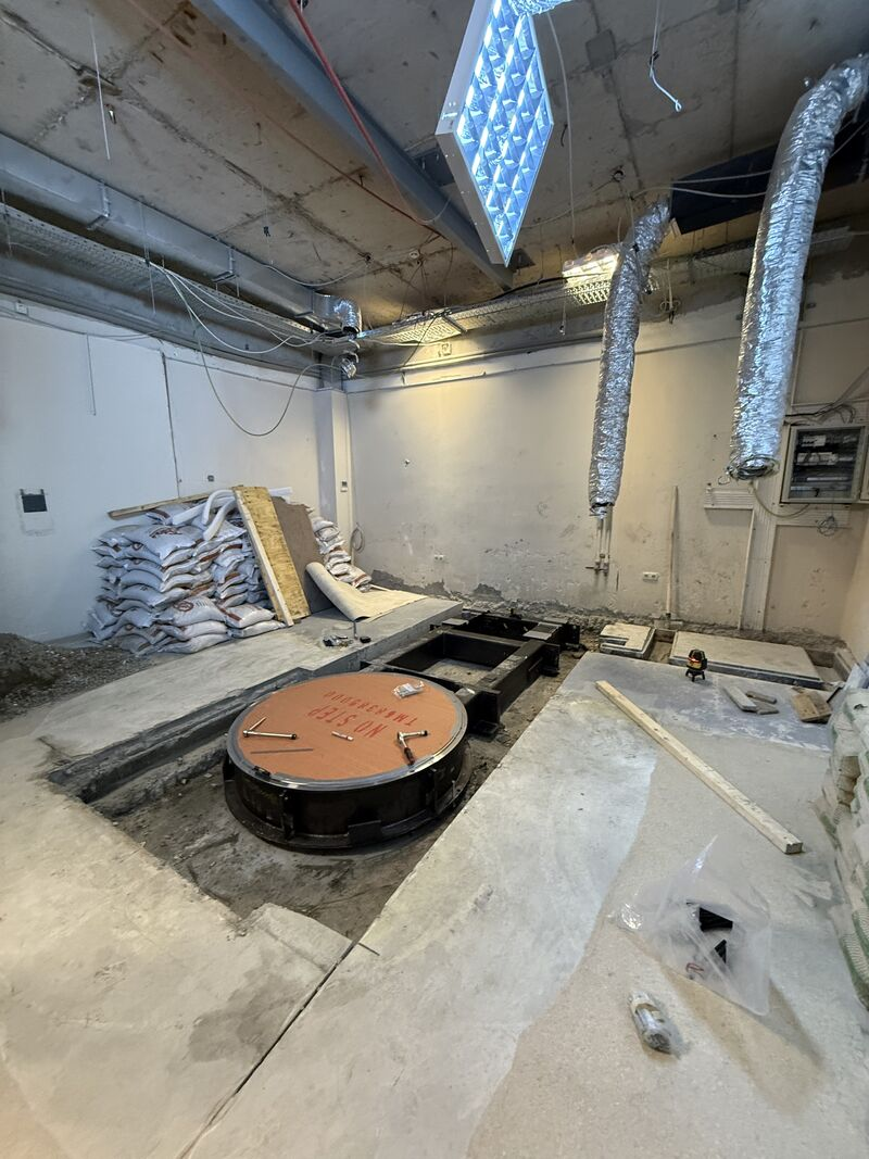 Circular equipment base beneath exposed ceiling services — Rize