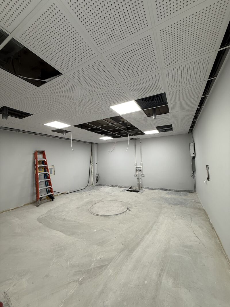 Room with ceiling panels partly installed — Rize